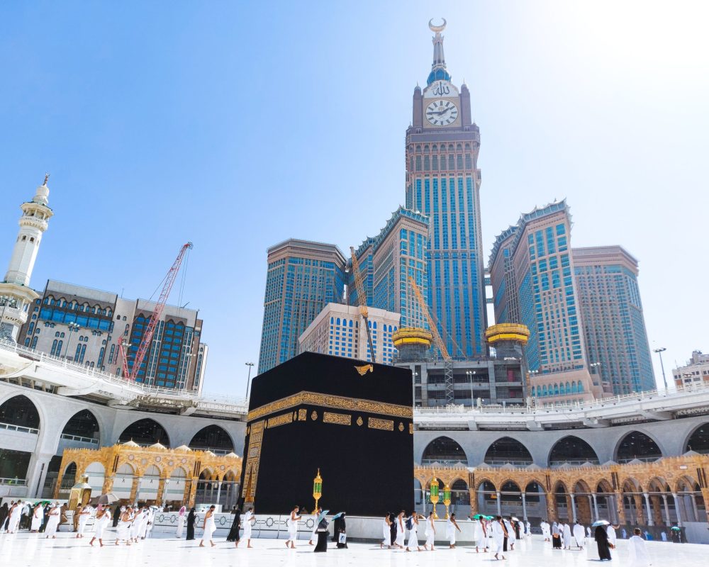 MECCA, SAUDI ARABIA , OCTOBER 22, 2020 - Pilgrims circle the Kaaba at Masjid al-Haram - umrah Fewer Muslims people Socially Distanced corona virus wearing face mask